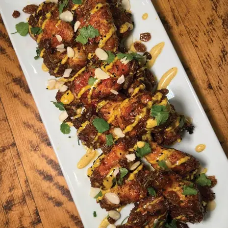 Explore Aston Prideaux's unique BBQ recipe for Coronation Chicken Wings, a novel blend of creamy curry mayo and sweet mango chutney. A real crowd-pleaser!