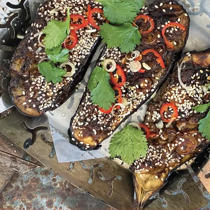 Experience the fusion of flavours with Miso-Charred Aubergines, a delightful blend of aubergines and Asian-inspired ingredients, cooked to perfection on a BBQ for a unique dining sensation.