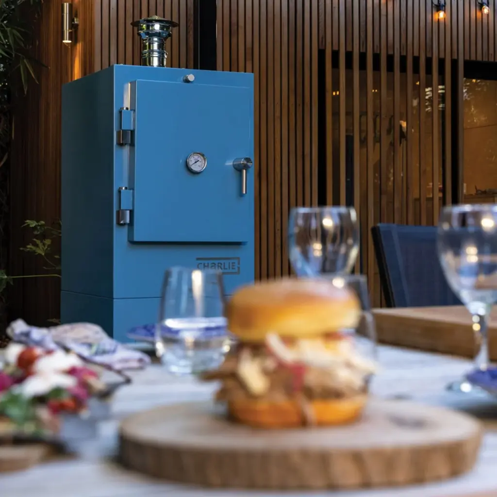 Charlie Oven can do just about anything in the live-fire firmament. A BBQ, smoker, charcoal oven and pizza oven, this outdoor cooking all-rounder is now a big player in the al fresco dining world.