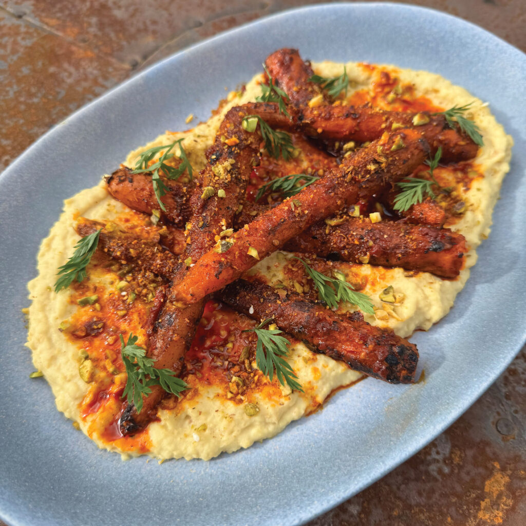 Cooking the carrots directly on the embers adds an additional depth of flavour to this tasty recipe. 