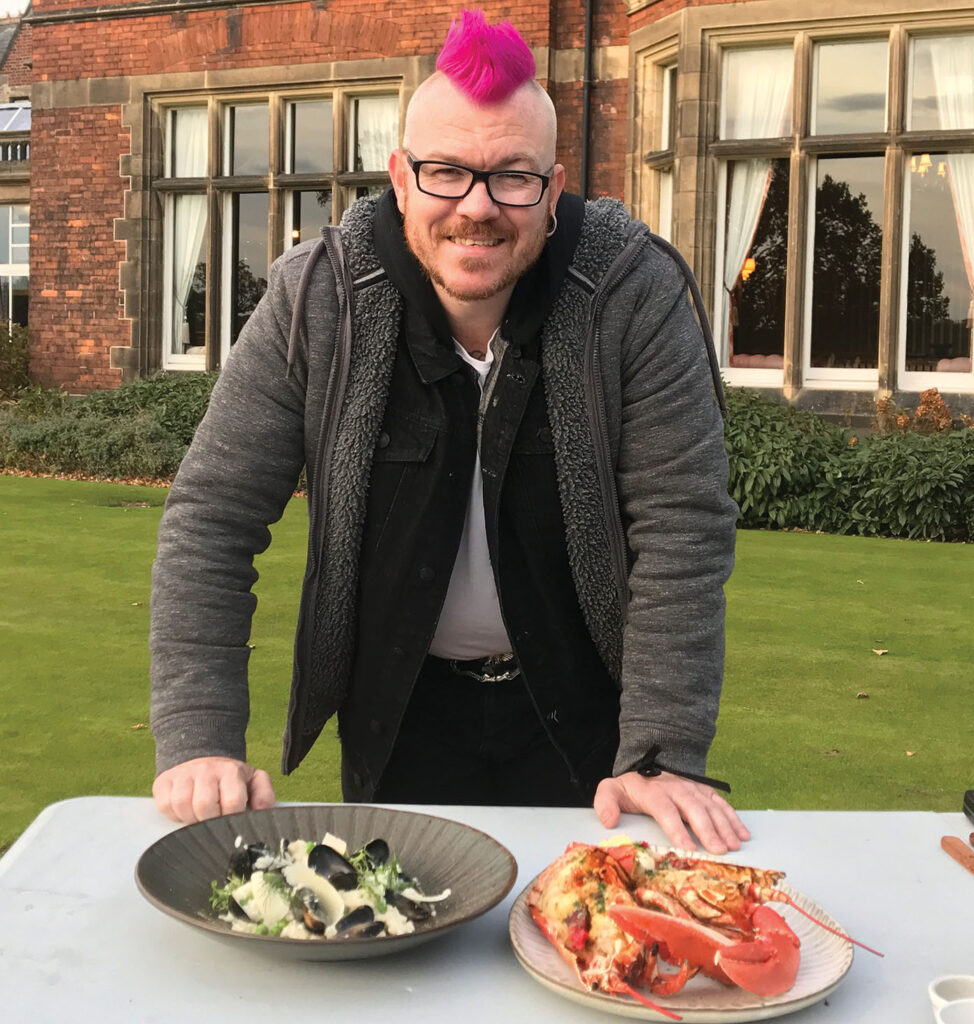The pink mohawk may give the name away, but Scott Garthwaite is a remarkable chef for so many reasons. TV producer ANDY CLARKE tells his inspiring story.
