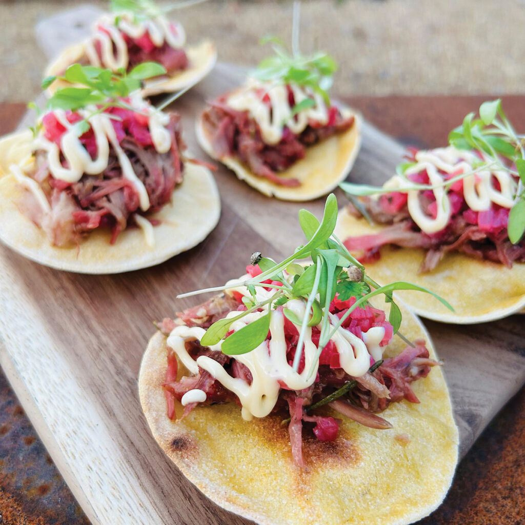 Tender applewood-smoked lamb shoulder, braised low and slow in local ale with ginger, lemongrass, and jalapeño, is piled onto homemade semolina tacos and crowned with a bright rhubarb and coriander salsa.